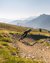 Mountain biker riding on winding trail in mountainous landscape