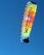 Colorful paraglider with Winkler Hotels advertisement against clear blue sky