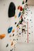 Child climbing a colorful indoor climbing wall in a gym