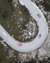 Aerial view of a winding mountain road with several cars