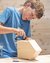 Boy carving a wooden object in a workshop