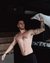 Tattooed man in sauna waving a white towel