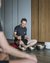 Man playing singing bowls during a meditation session with participant