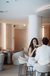 Couple sitting in modern café toasting with cocktails