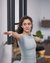 Woman with outstretched arms doing yoga pose indoors