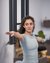 Woman with outstretched arms doing yoga pose indoors