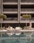 People by the pool with modern building in the background